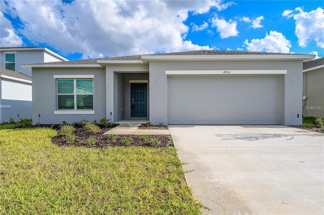 ranch-style home featuring a garage and a front lawn