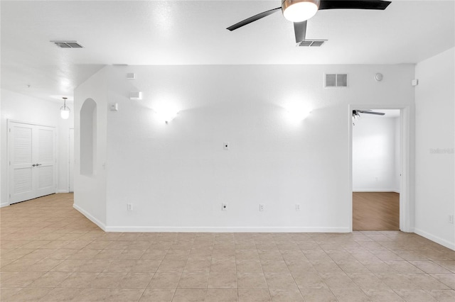 empty room featuring ceiling fan and light tile patterned floors