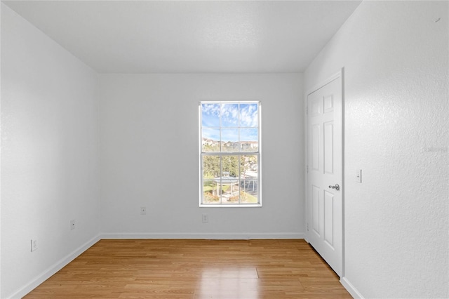 spare room featuring light wood-type flooring