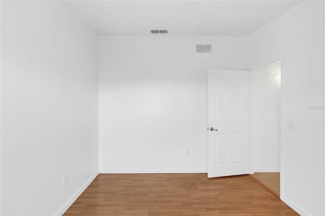 unfurnished room with hardwood / wood-style floors