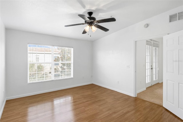 unfurnished room featuring ceiling fan, french doors, and light hardwood / wood-style floors