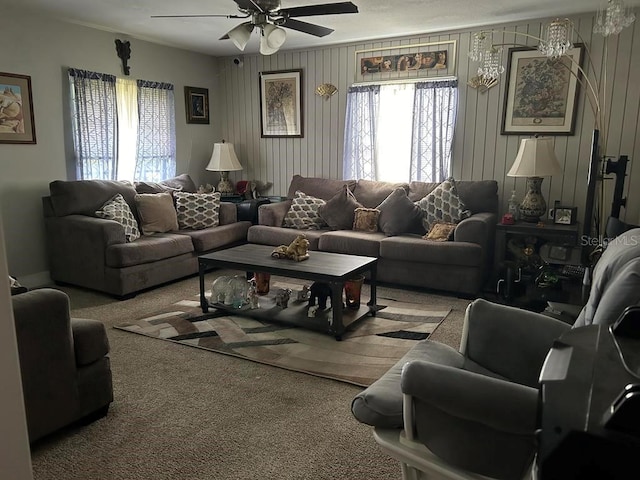 carpeted living room with ceiling fan, a wealth of natural light, and crown molding