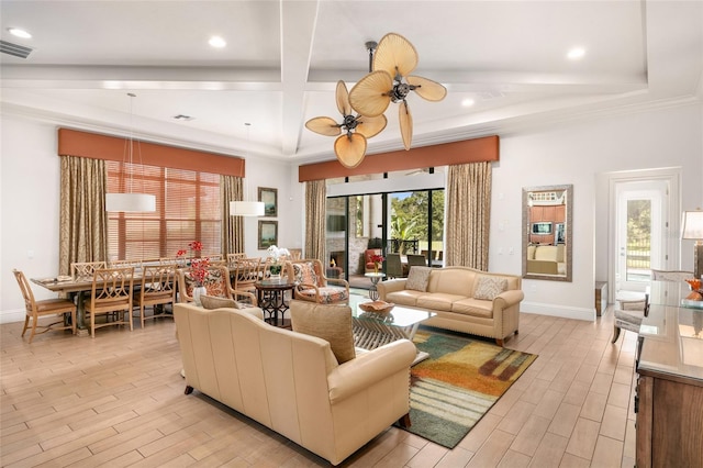 living room with a wealth of natural light, light hardwood / wood-style floors, and ceiling fan