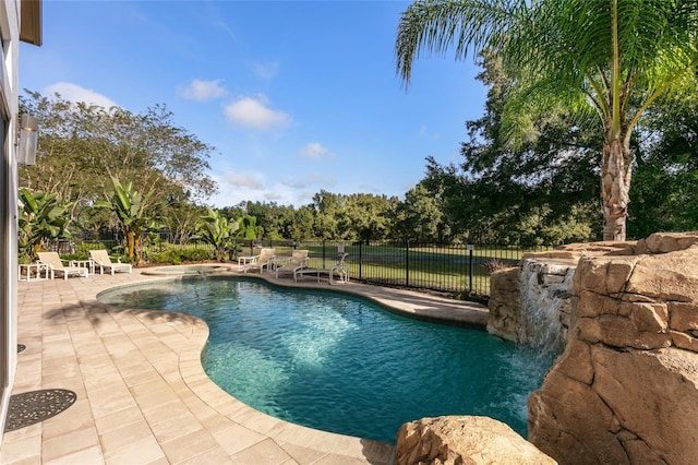 view of swimming pool with pool water feature and a patio