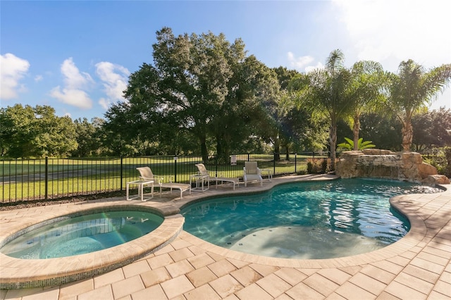 view of swimming pool with an in ground hot tub and a patio area