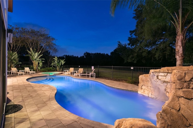 view of swimming pool featuring a patio area and an in ground hot tub