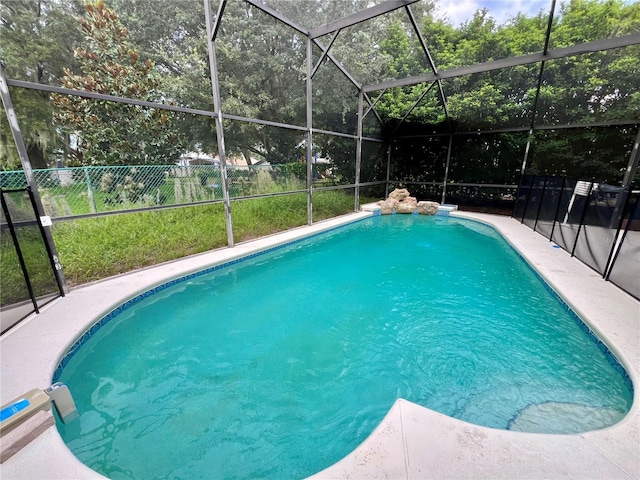 view of swimming pool with glass enclosure