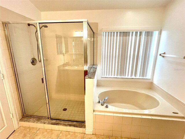 2556 Bear Creek Ct, Kissimmee, FL 34747 - bathroom with a bath, a shower stall, and tile patterned floors