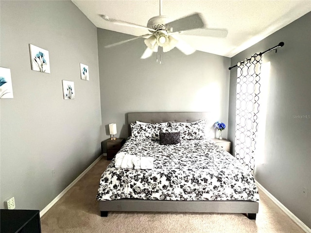 carpeted bedroom with vaulted ceiling, ceiling fan, and a textured ceiling