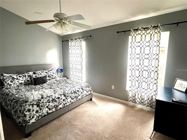 bedroom with ceiling fan, a textured ceiling, and carpet