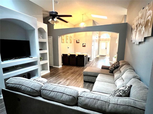 living room with wood-type flooring, vaulted ceiling, and ceiling fan