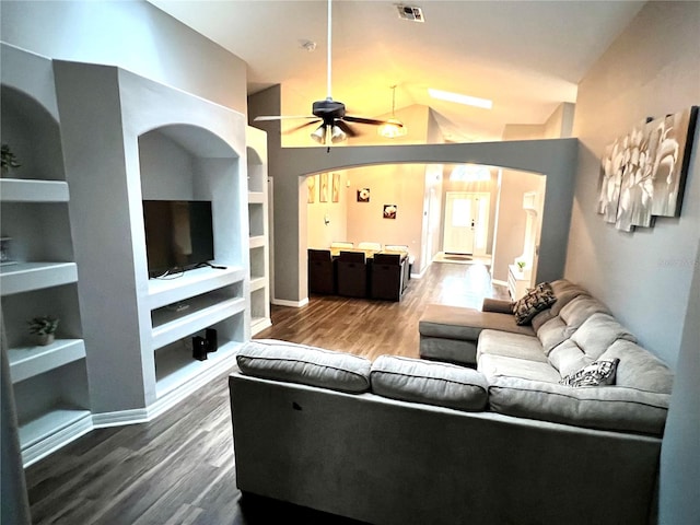 living room featuring vaulted ceiling, hardwood / wood-style floors, ceiling fan, and built in features