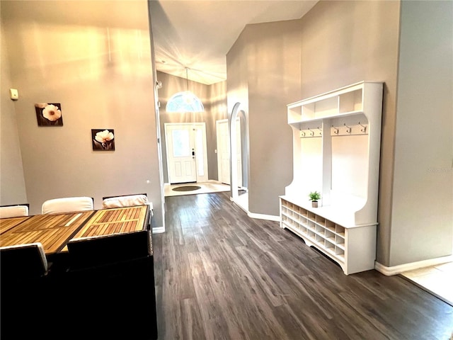 2556 Bear Creek Ct, Kissimmee, FL 34747 - foyer with dark wood finished floors, high vaulted ceiling, and baseboards