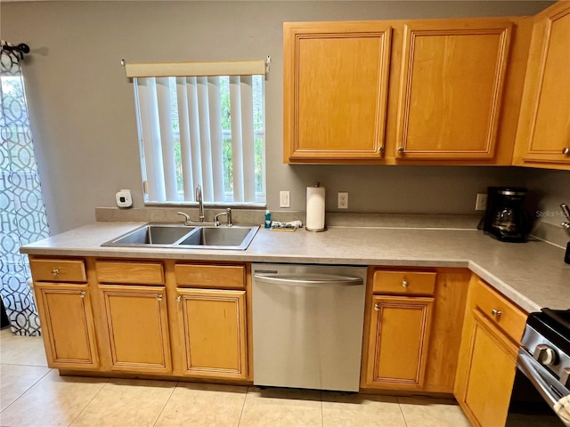 kitchen featuring light tile patterned floors, stainless steel appliances, sink, and a healthy amount of sunlight