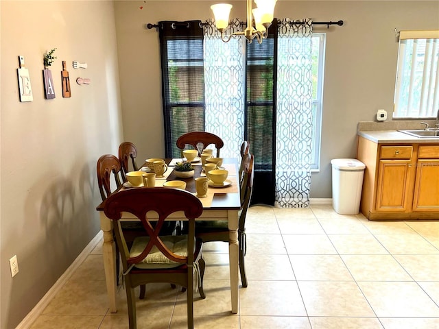 2556 Bear Creek Ct, Kissimmee, FL 34747 - dining space with a chandelier, healthy amount of natural light, baseboards, and light tile patterned flooring