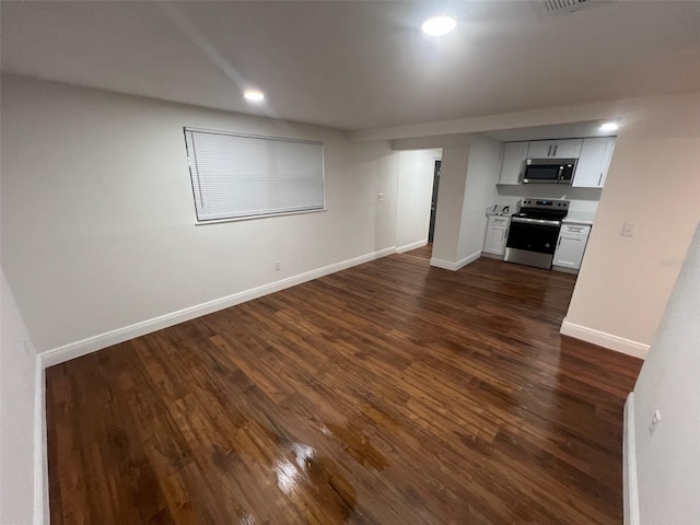 unfurnished living room with recessed lighting, dark wood-style floors, and baseboards