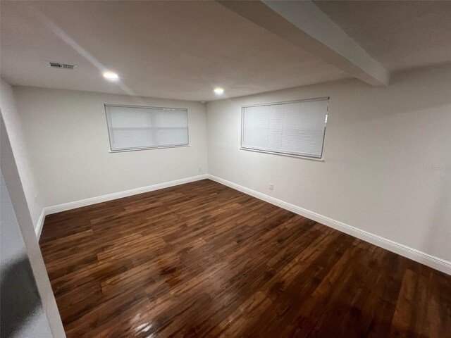 unfurnished room featuring visible vents, baseboards, beamed ceiling, recessed lighting, and dark wood-style flooring