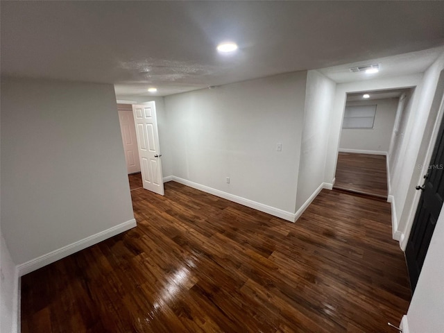 basement featuring dark hardwood / wood-style flooring