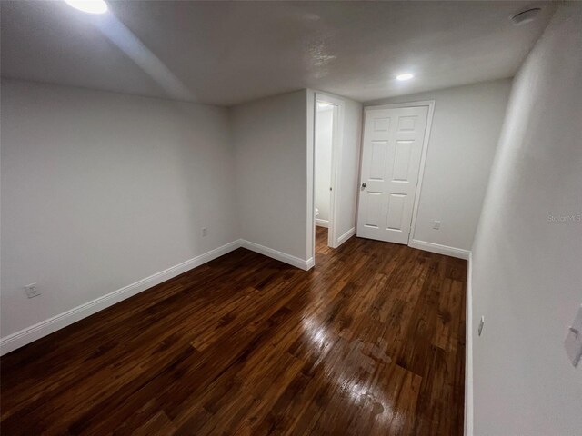 interior space featuring dark wood-style floors and baseboards