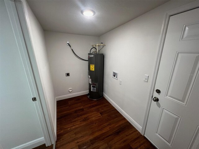 clothes washing area with dark wood-style floors, baseboards, laundry area, water heater, and electric dryer hookup