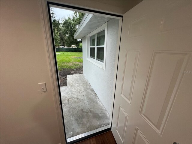 doorway to outside featuring dark wood-type flooring