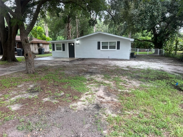 ranch-style home with stucco siding, central AC, and fence