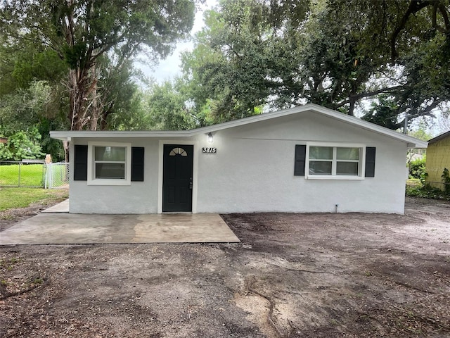 single story home with stucco siding and fence