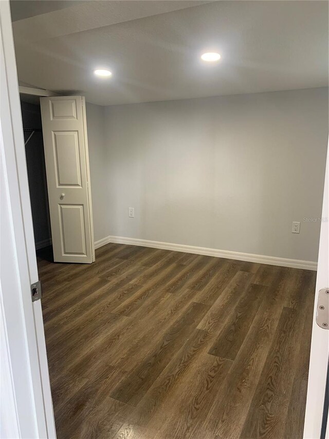 empty room featuring dark hardwood / wood-style flooring