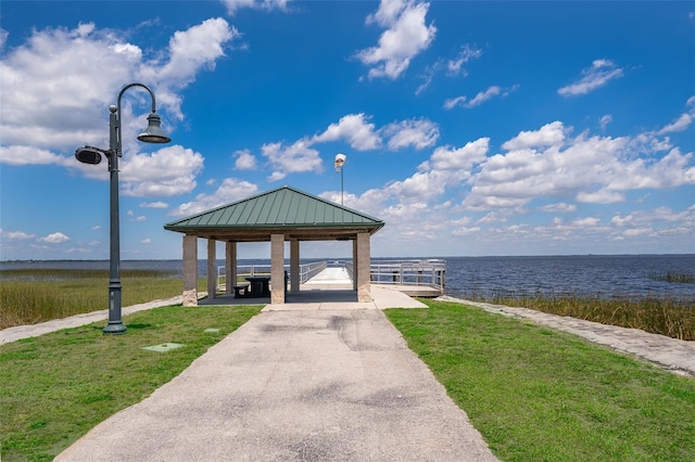 view of home's community with a water view, a yard, and a gazebo