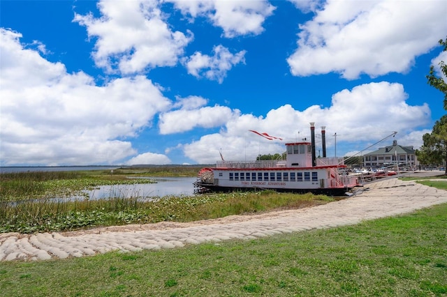 surrounding community with a yard and a water view