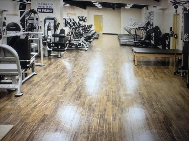 workout area with hardwood / wood-style flooring