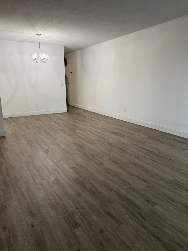 2070 World Parkway Blvd Unit 50, Clearwater, FL 33763 - spare room featuring a chandelier, dark wood finished floors, and a textured ceiling
