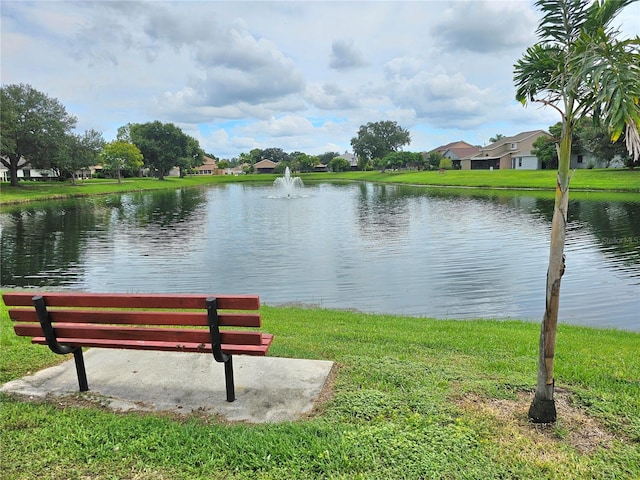 surrounding community featuring a water view and a yard