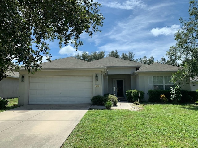 single story home featuring a front lawn and a garage