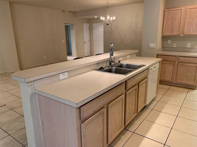 kitchen featuring decorative light fixtures, white dishwasher, a center island, and sink