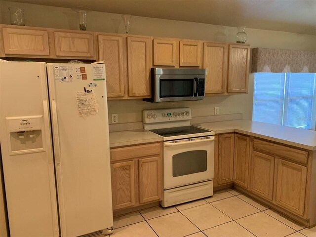 kitchen with white appliances, light brown cabinetry, and light tile patterned flooring