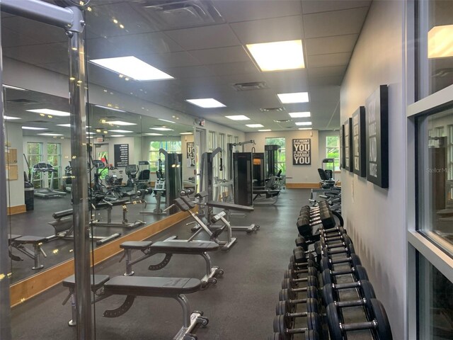 exercise room with a paneled ceiling