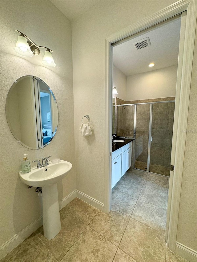 bathroom featuring an enclosed shower and tile patterned floors