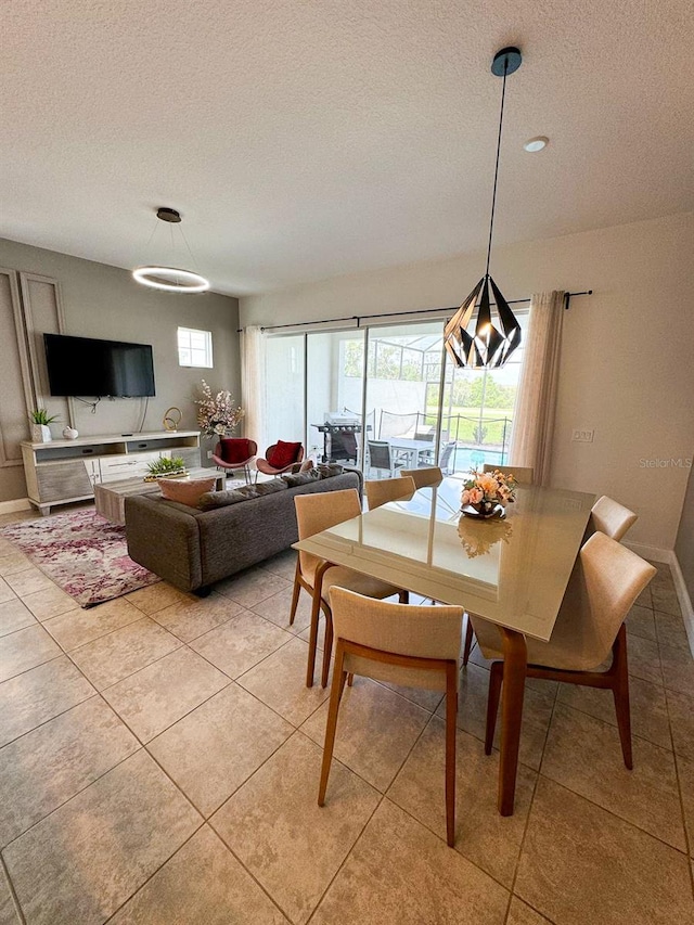 dining space with light tile patterned floors and a textured ceiling