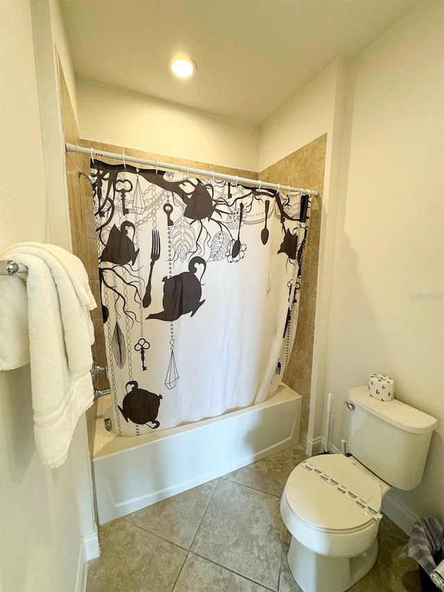 bathroom with toilet, shower / tub combo, and tile patterned floors