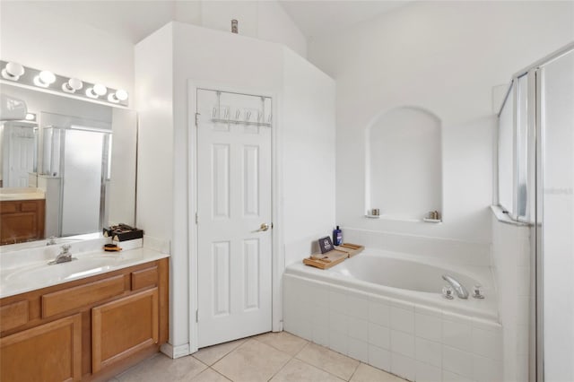 bathroom with vanity, tile patterned floors, and plus walk in shower