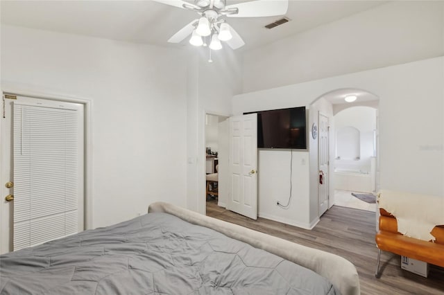 bedroom featuring ensuite bathroom, ceiling fan, and light hardwood / wood-style flooring