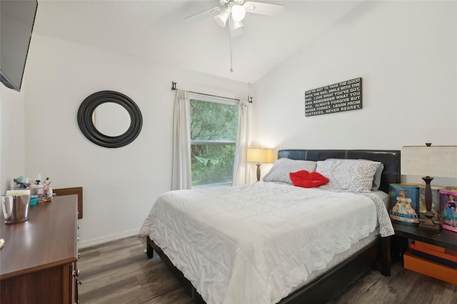 bedroom featuring dark hardwood / wood-style floors, ceiling fan, and vaulted ceiling