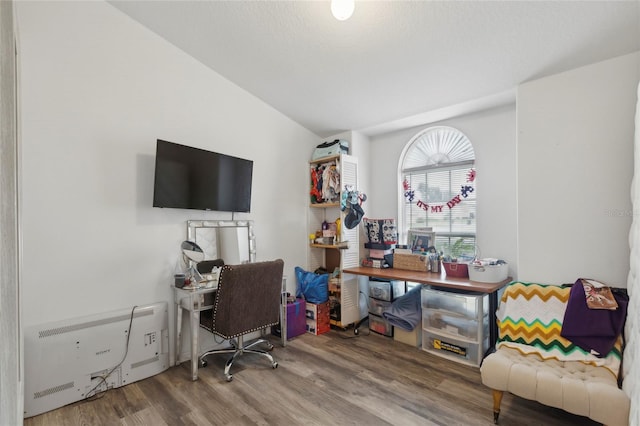 office space with hardwood / wood-style floors and lofted ceiling