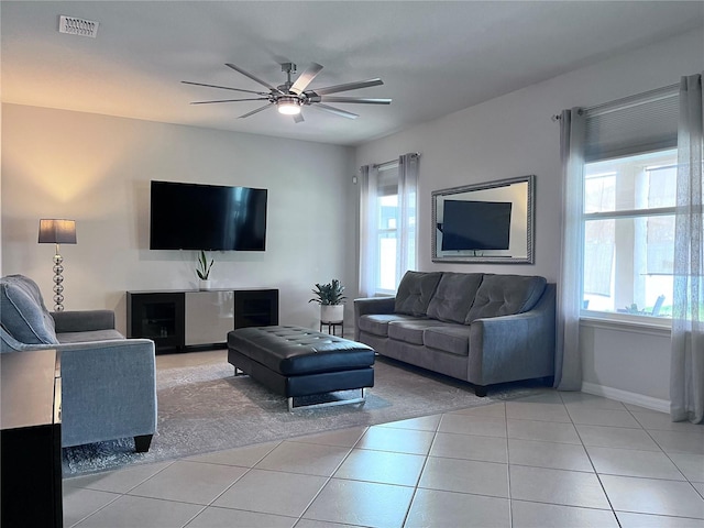 living room featuring plenty of natural light, ceiling fan, light tile patterned flooring, and visible vents