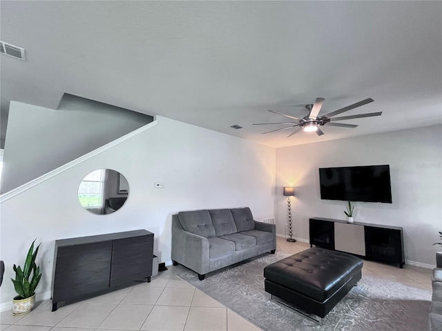 living room with light tile patterned floors, ceiling fan, and visible vents