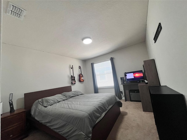 carpeted bedroom with a textured ceiling and visible vents