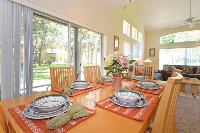 dining area with carpet flooring, vaulted ceiling, and ceiling fan