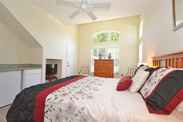 bedroom with ceiling fan, carpet flooring, and a high ceiling