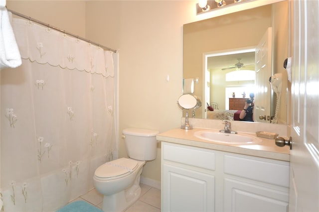 full bathroom with ceiling fan, vanity, shower / bath combo with shower curtain, tile patterned floors, and toilet